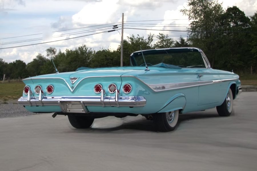 Turquoise 1961 Chevrolet Impala SS Convertible, rear three quarter view with the signature six taillights